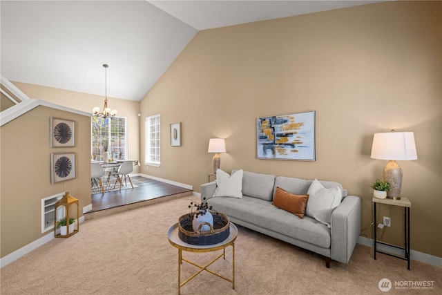 carpeted living area featuring a chandelier, baseboards, and high vaulted ceiling