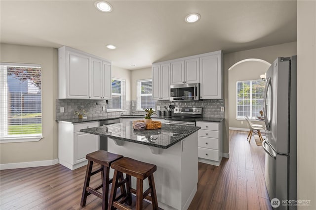 kitchen featuring stainless steel appliances, white cabinets, baseboards, dark wood-style floors, and recessed lighting