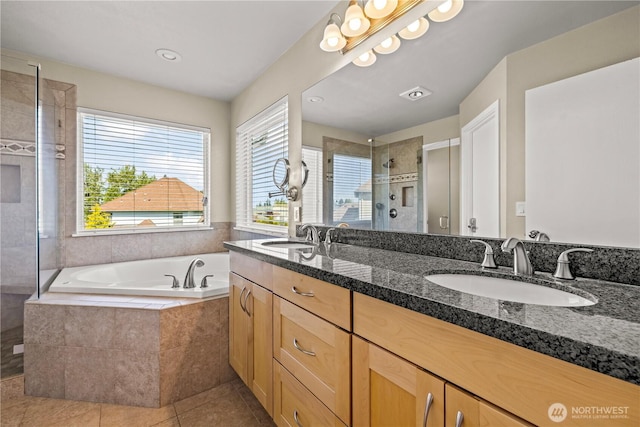 bathroom with a shower stall, tile patterned floors, a garden tub, and double vanity