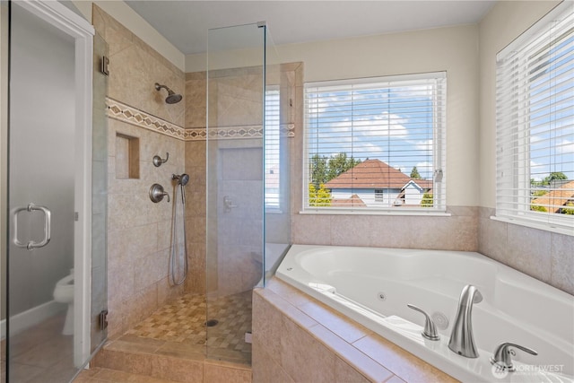full bathroom with a stall shower, a tub with jets, and tile patterned flooring
