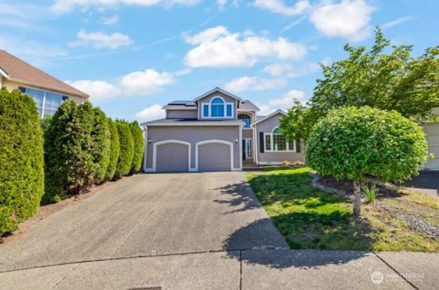 10024 SE 244th Ct, Kent, WA 98030 - traditional-style house featuring solar panels, concrete driveway, and an attached garage