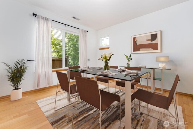 dining room featuring light wood-style floors and baseboards