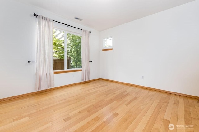 spare room featuring wood finished floors and baseboards