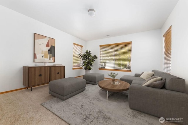 carpeted living room with baseboards