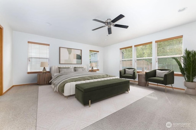 carpeted bedroom featuring multiple windows, baseboards, and a ceiling fan