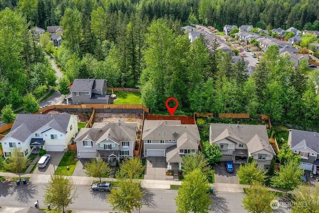 aerial perspective of suburban area with a forest