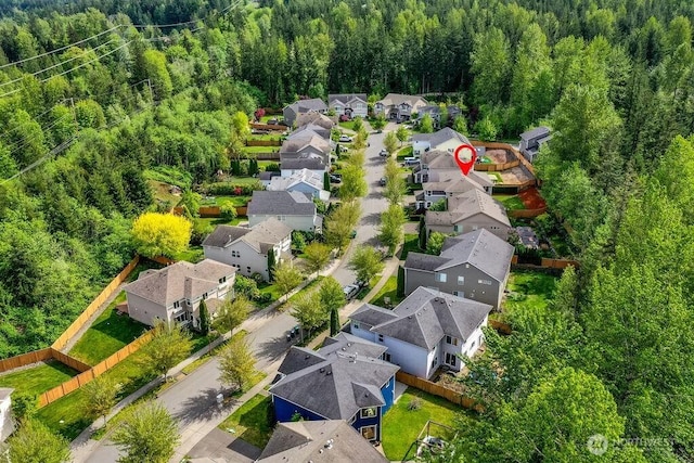 aerial view of residential area with a heavily wooded area