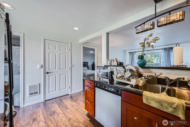 4503 Yew Ln SW, Lakewood, WA 98499 - kitchen featuring dishwasher, wood finished floors, dark countertops, recessed lighting, and brown cabinetry