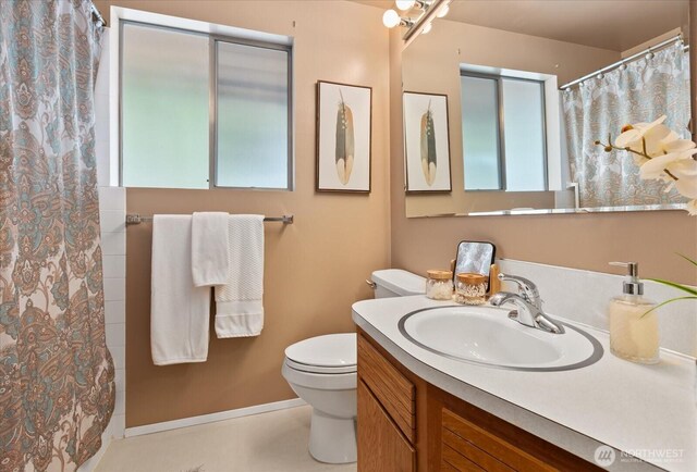 10918 Vernon Rd, Lake Stevens, WA 98258 - bathroom featuring toilet, vanity, curtained shower, and baseboards