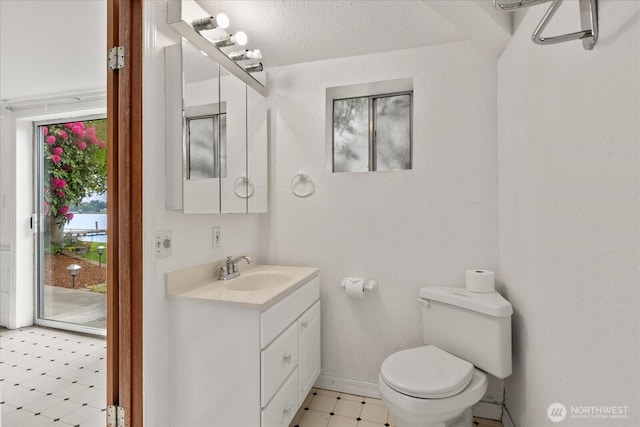 10918 Vernon Rd, Lake Stevens, WA 98258 - half bathroom with tile patterned floors, toilet, vanity, and baseboards