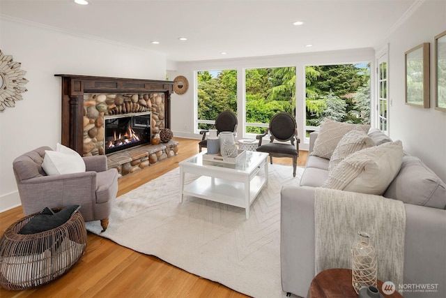 3204 Evergreen Point Rd, Medina, WA 98039 - living area featuring wood finished floors, ornamental molding, a stone fireplace, and recessed lighting