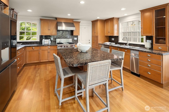 3204 Evergreen Point Rd, Medina, WA 98039 - kitchen featuring wall chimney exhaust hood, stove, a sink, light wood-style flooring, and tasteful backsplash