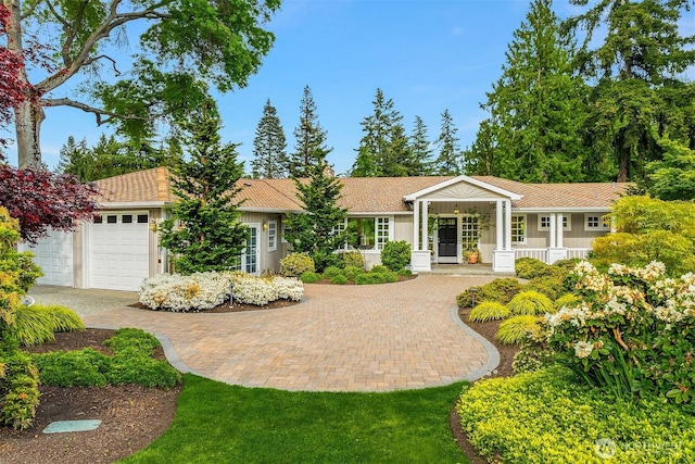 3204 Evergreen Point Rd, Medina, WA 98039 - ranch-style house with driveway, a garage, and a porch