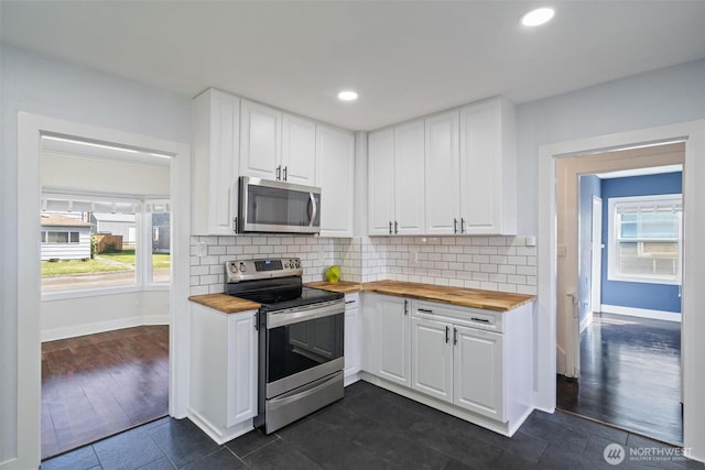 166 SW Lewis St, Chehalis, WA 98532 - kitchen with stainless steel appliances, butcher block countertops, baseboards, white cabinetry, and recessed lighting