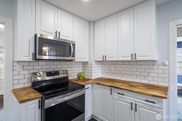 166 SW Lewis St, Chehalis, WA 98532 - kitchen with wood counters, stainless steel appliances, white cabinetry, and decorative backsplash