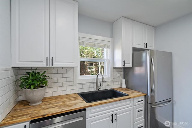 166 SW Lewis St, Chehalis, WA 98532 - kitchen featuring wood counters, stainless steel appliances, a sink, and white cabinets