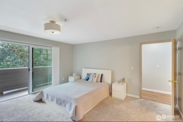 carpeted bedroom featuring access to outside and baseboards
