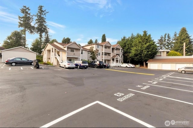 uncovered parking lot featuring a residential view