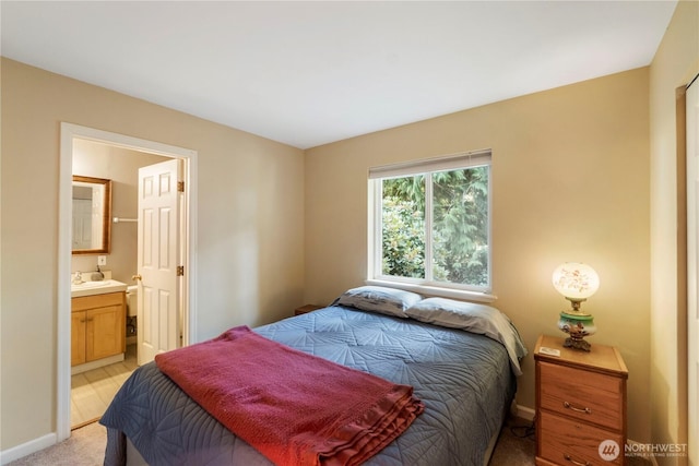11011 Seaview Dr, Anderson Island, WA 98303 - bedroom with ensuite bathroom, baseboards, and light carpet