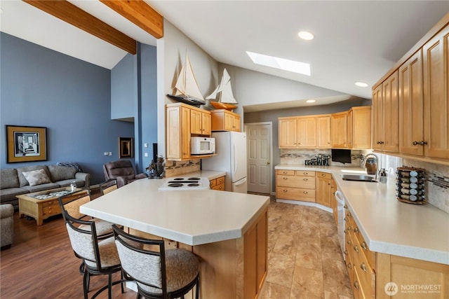 11011 Seaview Dr, Anderson Island, WA 98303 - kitchen with white appliances, a sink, a skylight, a peninsula, and light countertops