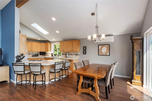 11011 Seaview Dr, Anderson Island, WA 98303 - dining space with lofted ceiling, dark wood finished floors, a chandelier, a skylight, and recessed lighting