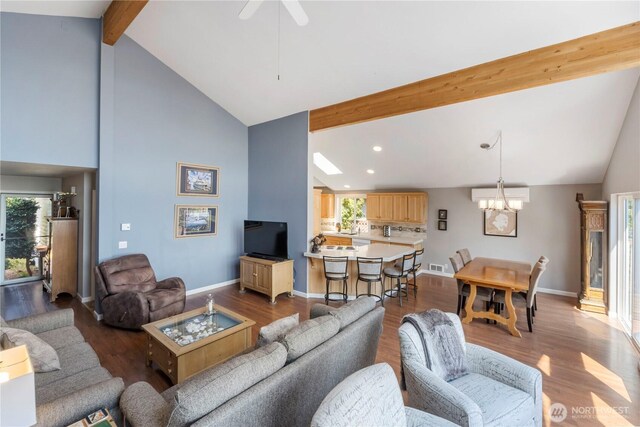 11011 Seaview Dr, Anderson Island, WA 98303 - living area with beam ceiling, wood finished floors, a chandelier, baseboards, and high vaulted ceiling