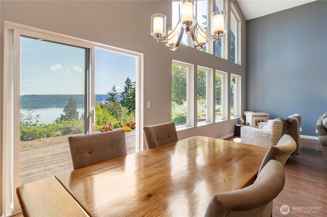 11011 Seaview Dr, Anderson Island, WA 98303 - dining room featuring a chandelier, wood finished floors, and a towering ceiling