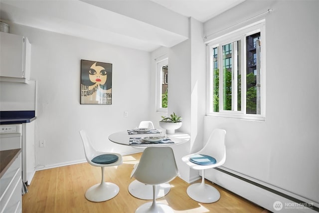 1200 Boylston Ave Unit 301, Seattle, WA 98101 - dining space featuring baseboard heating, wood finished floors, healthy amount of natural light, and baseboards