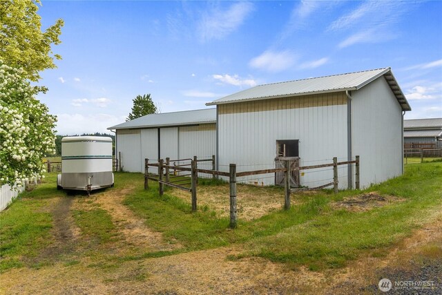 view of pole building featuring fence