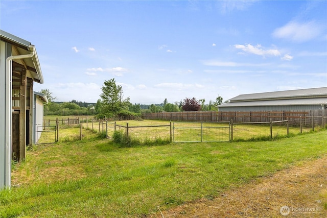 view of yard with a view of countryside and a gate