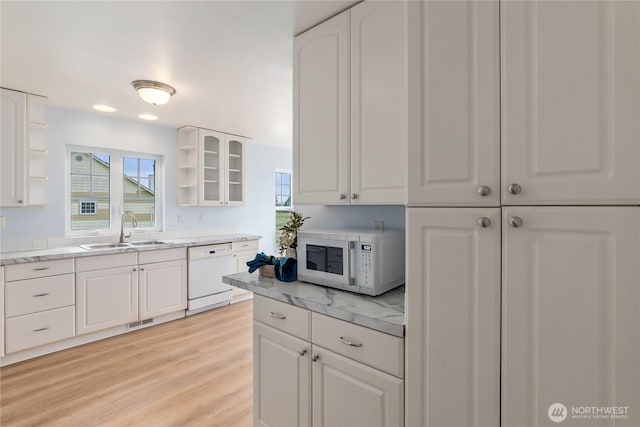kitchen with white appliances, a sink, open shelves, and white cabinets