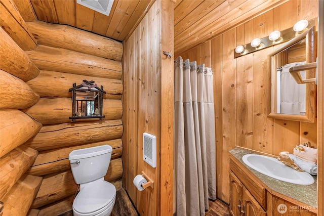 bathroom featuring toilet, vanity, wood ceiling, heating unit, and a skylight