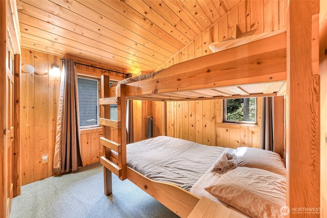 bedroom featuring wood walls, carpet flooring, and wooden ceiling