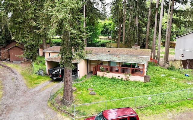 11409 205th Ave E, Bonney Lake, WA 98391 - single story home with dirt driveway, fence, and a storage unit