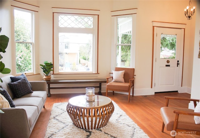 123 24th Ave, Seattle, WA 98122 - living room with healthy amount of natural light, wood finished floors, a chandelier, and baseboards