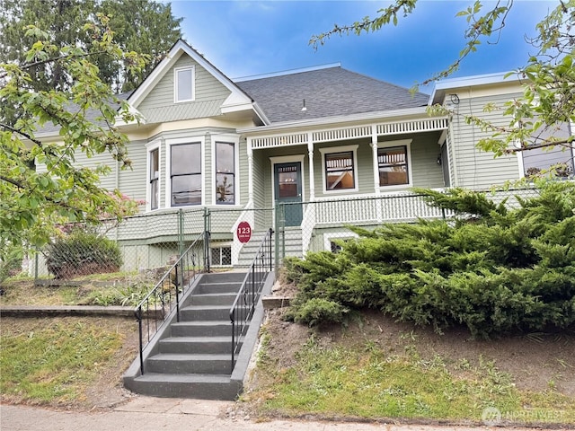 123 24th Ave, Seattle, WA 98122 - victorian home featuring a shingled roof, a porch, and fence