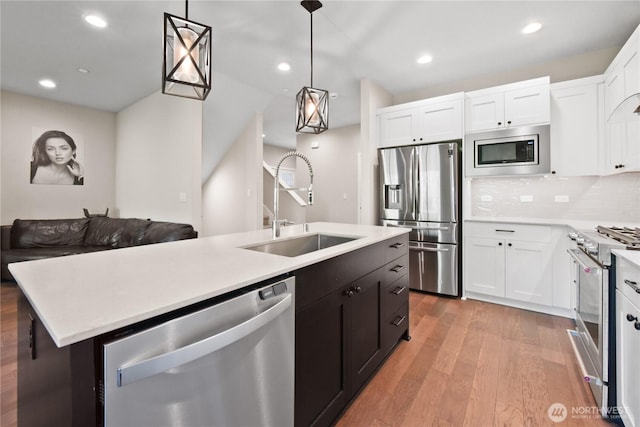 1086 Collier Pl SW, Issaquah, WA 98027 - kitchen with appliances with stainless steel finishes, a sink, white cabinetry, light countertops, and recessed lighting