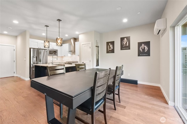 1086 Collier Pl SW, Issaquah, WA 98027 - dining area with a wall unit AC, light wood finished floors, baseboards, and recessed lighting