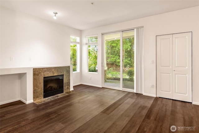 21450 40th Pl S Unit A, Seatac, WA 98198 - unfurnished living room with baseboards, a tile fireplace, and wood finished floors