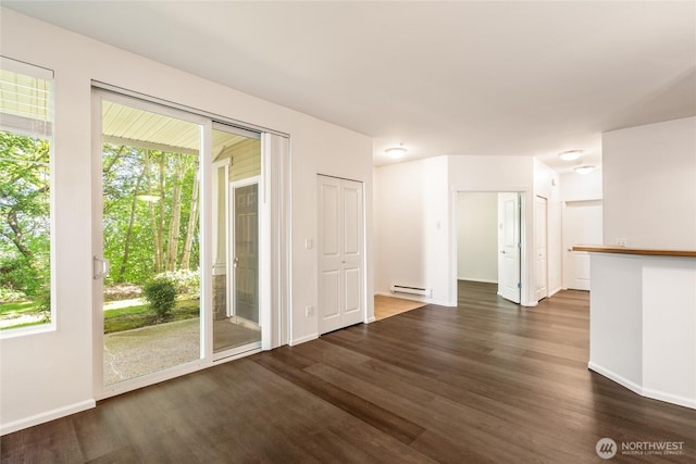 21450 40th Pl S Unit A, Seatac, WA 98198 - empty room featuring a baseboard heating unit, dark wood-style floors, and baseboards