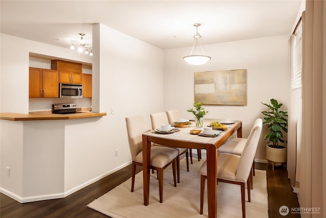 21450 40th Pl S Unit A, Seatac, WA 98198 - dining room with dark wood finished floors and baseboards