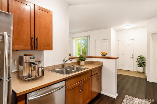 21450 40th Pl S Unit A, Seatac, WA 98198 - kitchen featuring appliances with stainless steel finishes, a sink, dark wood-style flooring, brown cabinetry, and light countertops