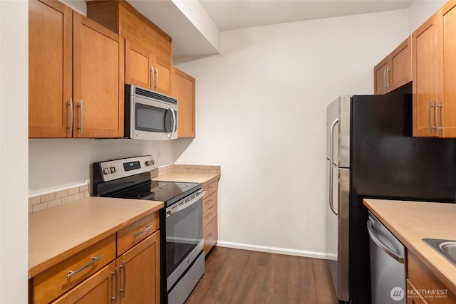 21450 40th Pl S Unit A, Seatac, WA 98198 - kitchen with stainless steel appliances, dark wood finished floors, light countertops, and brown cabinets
