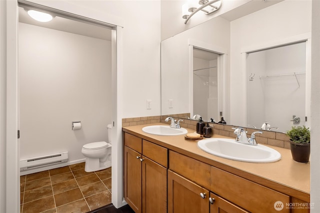21450 40th Pl S Unit A, Seatac, WA 98198 - full bathroom with a baseboard heating unit, toilet, and double vanity
