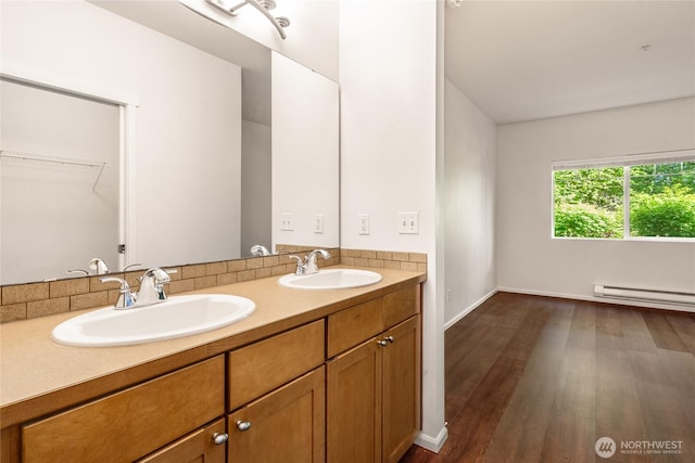 21450 40th Pl S Unit A, Seatac, WA 98198 - bathroom with wood finished floors, a baseboard heating unit, double vanity, and baseboards