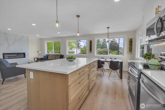1246 SW 148th St, Burien, WA 98166 - kitchen featuring stainless steel appliances, light wood-type flooring, healthy amount of natural light, open floor plan, and recessed lighting