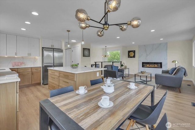 1246 SW 148th St, Burien, WA 98166 - dining room featuring a chandelier, light wood-style floors, recessed lighting, and a high end fireplace