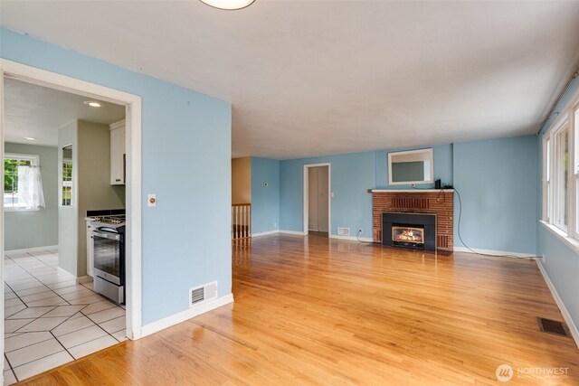 414 W Wyandotte Ave, Shelton, WA 98584 - unfurnished living room featuring a fireplace and light wood-type flooring