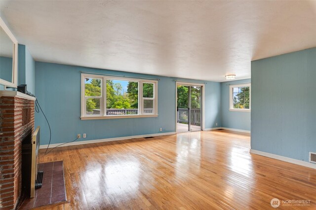 414 W Wyandotte Ave, Shelton, WA 98584 - unfurnished living room with a brick fireplace and wood finished floors