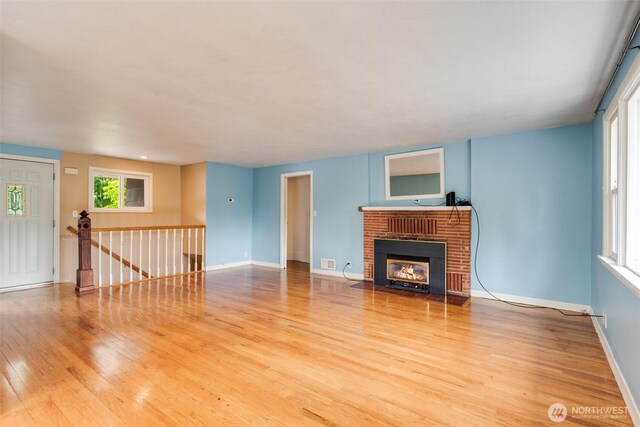 414 W Wyandotte Ave, Shelton, WA 98584 - unfurnished living room featuring light wood-type flooring and a brick fireplace